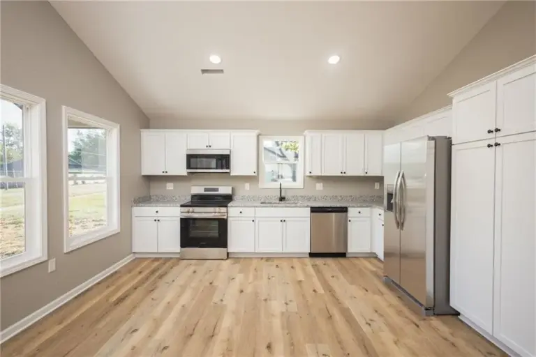 Kitchen with white cabinets at 305 E Pacific St, Holden, Missouri - DRAT House 2