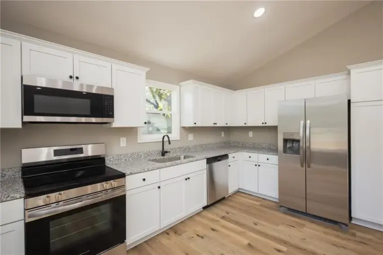Kitchen cabinets and appliances at 305 E Pacific St, Holden, Missouri - DRAT House 2