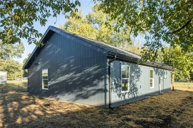 Side exterior and yard at 305 E Pacific St, Holden, Missouri - DRAT House 2