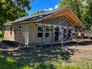 Siding installation around the front porch at DRAT House #2 in Holden, Missouri