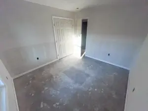 Bedroom drywall and door installation at DRAT House #2 in Holden, Missouri